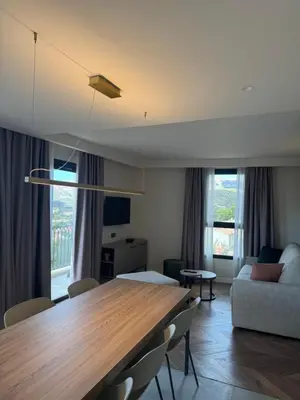 a living room with a table and a couch at Résidence Apa Nera in Calenzana