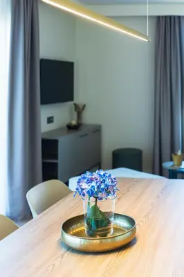 a vase of blue flowers on a plate on a table at Résidence Apa Nera in Calenzana