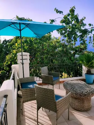 two blue chairs and a table on a patio at Maison Corse avec piscine et sauna - La Casa Lilia in Campile