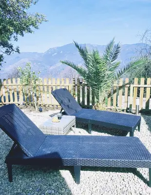 two pictures of a bedroom with two beds at Maison Corse avec piscine et sauna - La Casa Lilia in Campile