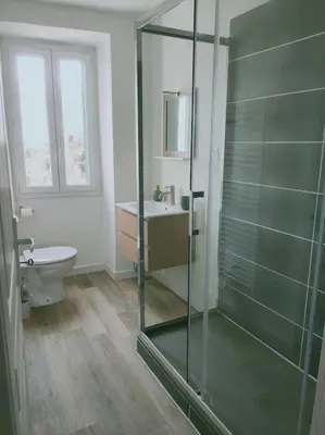 a bathroom with a glass shower and a toilet at Maison Corse avec piscine et sauna - La Casa Lilia in Campile