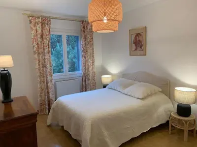 a bedroom with a white bed and a window at Appartement T4 climatisé, lumineux et vue mer à Solenzara in Sari Solenzara