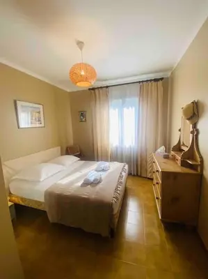 a bedroom with a large bed and a window at Appartement T4 climatisé, lumineux et vue mer à Solenzara in Sari Solenzara