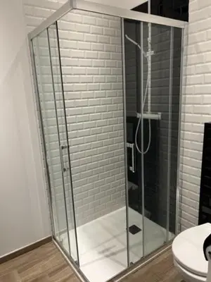 a glass shower in a bathroom with a toilet at Résidence Cas’Antica in Propriano