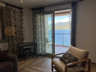 a living room with a view of the ocean at Résidence Cas’Antica in Propriano