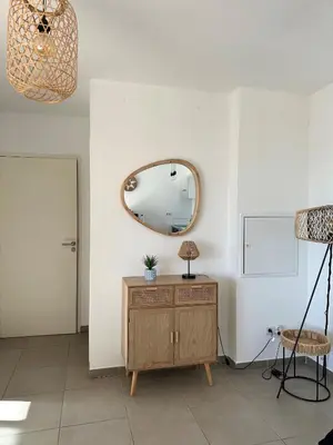 a room with a wooden dresser and a mirror at Porto vecchio Résidence Don Andria T2 in Lecci