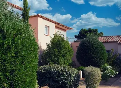 a pink house with trees in front of it at Porto vecchio Résidence Don Andria T2 in Lecci