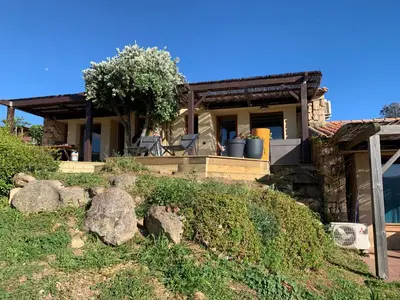 a house with some rocks in front of it at La bergerie de Cupabia in Serra-di-Ferro