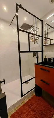 a room with a white wall with shelves and a dresser at La bergerie de Cupabia in Serra-di-Ferro