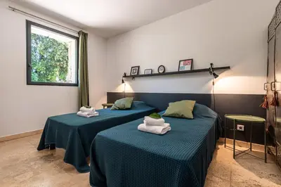 two beds in a room with towels on them at Locations de La Casette d'Araggio in Porto-Vecchio
