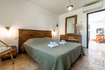 a bedroom with a bed with two towels on it at Locations de La Casette d'Araggio in Porto-Vecchio