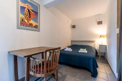 a small room with a bed and a table at Locations de La Casette d'Araggio in Porto-Vecchio