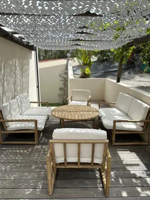 a patio with chairs and a table and chairs at Appartement T2 Casa Di Simone Pietrosella Corse du Sud in Pietrosella
