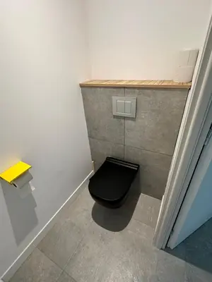 a bathroom with a toilet with a black toilet seat at Appartement T2 Casa Di Simone Pietrosella Corse du Sud in Pietrosella