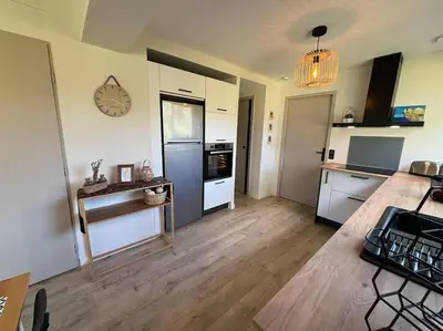 a room with a kitchen with a refrigerator and a table at Gîte Cazoletta in Casalabriva
