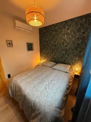 a bedroom with a bed with a stone wall at Gîte Cazoletta in Casalabriva