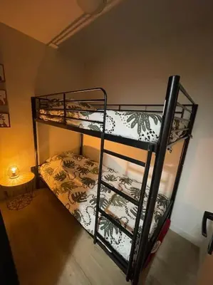 a room with two bunk beds and a table at Gîte Cazoletta in Casalabriva