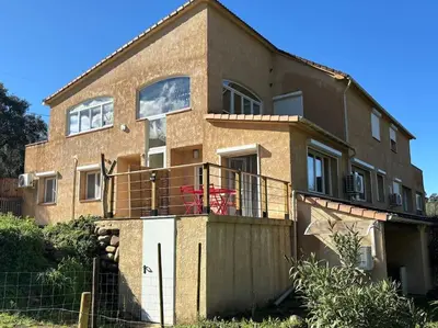a brick house with a balcony in front of it at Gîte Cazoletta in Casalabriva