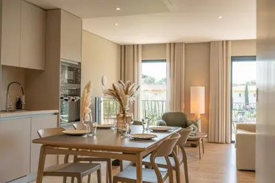 a bedroom with a bed and a kitchen with a counter at CADIAMARE in Zonza