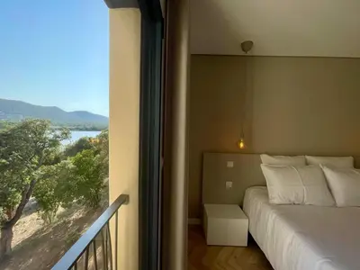 a living room with a flat screen tv and a table at CADIAMARE in Zonza