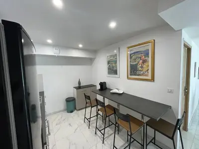 a dining room with a table and chairs at Rez de villa golfe de lava in Appietto