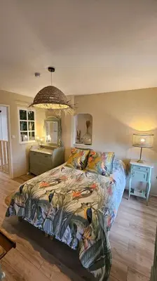 a bedroom with a bed with a colorful comforter at Maison de famille in Vallecalle
