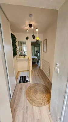 a hallway of a home with a rug on the floor at Maison de famille in Vallecalle