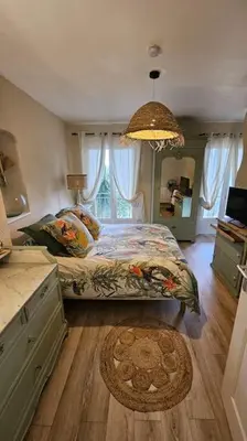 a bedroom with a bed and a large window at Maison de famille in Vallecalle