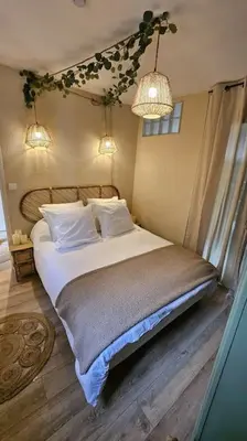 a bedroom with a bed with white sheets and pillows at Maison de famille in Vallecalle
