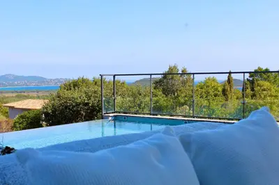 a swimming pool with a view of the water at Villa A Pinetta Villata in Sainte-Lucie de Porto-Vecchio