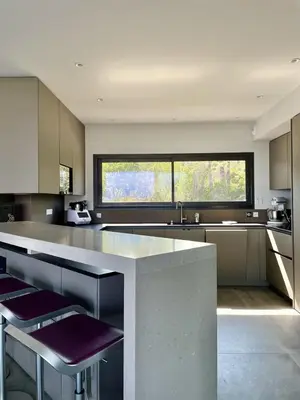a kitchen with a counter and a large window at Villa A Pinetta Villata in Sainte-Lucie de Porto-Vecchio