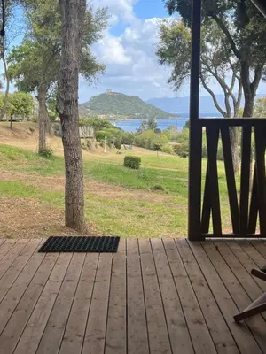 a porch with a view of a tree and the ocean at lodge lavallee in Belvédère