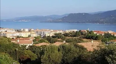 a city with a large body of water and a town at Appartement vue mer Les hameaux de Propriano à Propriano in Propriano