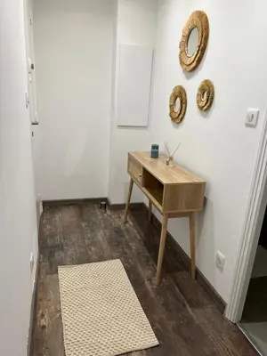 a room with a table and a mirror on the wall at Appartement Centre Ville Dea in Ajaccio