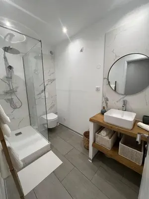 a bathroom with a shower and a sink and a mirror at Appartement Centre Ville Dea in Ajaccio
