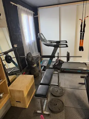 a room with a gym with a bike and a treadmill at Maison 47m2 à 10min des plages - billard, baby, salle de sport, jardin in Ajaccio