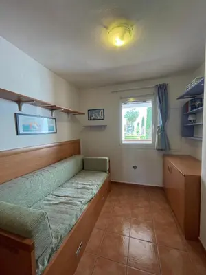 a small room with a bed and a window at Appartement T3 les pieds dans l'eau in Moriani Plage