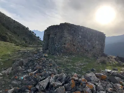 a large pile of rocks next to a stone wall at La Corse authentique et rurale in Castifao