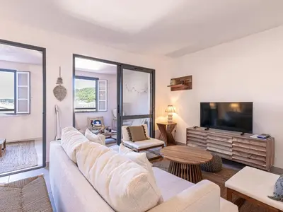 a living room with a couch and a tv at Apartment Odeva by Interhome in Bonifacio