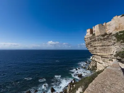a castle on a cliff next to the ocean at Apartment Odeva by Interhome in Bonifacio
