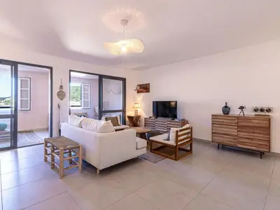 a living room with a white couch and a tv at Apartment Odeva by Interhome in Bonifacio