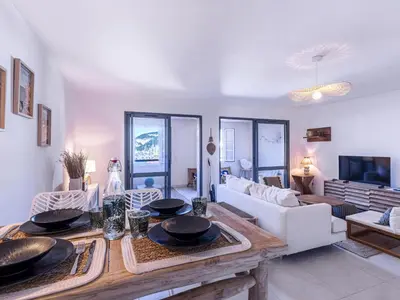 a living room with a table and a couch at Apartment Odeva by Interhome in Bonifacio