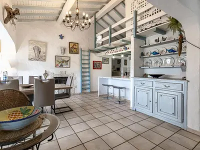 a kitchen and dining room with a table and chairs at Holiday Home Paulka by Interhome in Sainte-Lucie de Porto-Vecchio