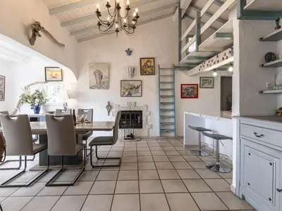 a kitchen and dining room with a table and chairs at Holiday Home Paulka by Interhome in Sainte-Lucie de Porto-Vecchio