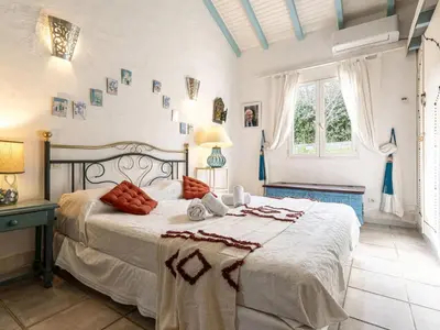 a bedroom with a large bed in a room at Holiday Home Paulka by Interhome in Sainte-Lucie de Porto-Vecchio