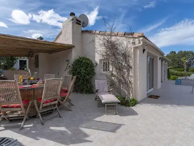an outdoor patio with a table and chairs at Holiday Home Paulka by Interhome in Sainte-Lucie de Porto-Vecchio