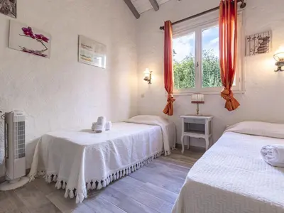 a white room with two beds and a window at Holiday Home Samba by Interhome in Sainte-Lucie de Porto-Vecchio