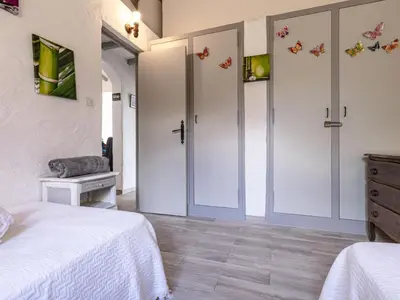 a bedroom with two beds and butterflies on the walls at Holiday Home Samba by Interhome in Sainte-Lucie de Porto-Vecchio