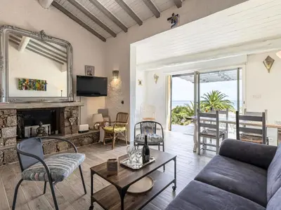 a living room with a couch and a fireplace at Holiday Home Samba by Interhome in Sainte-Lucie de Porto-Vecchio
