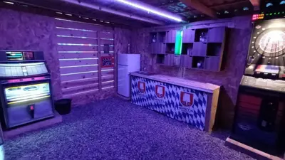 a room with a purple room with a video game system at Maison de vacances avec piscine proche mer et montagne in Ghisonaccia